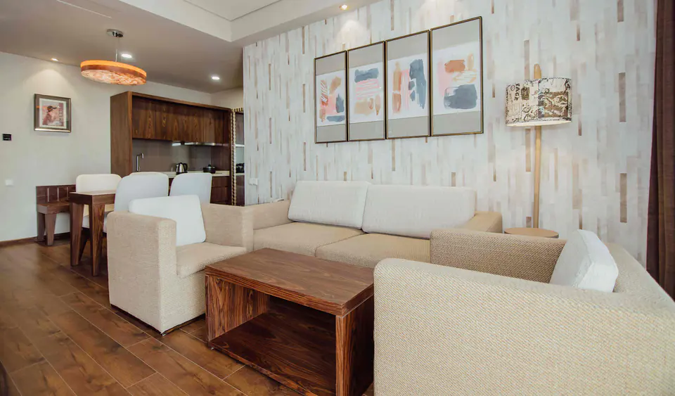 Living room of an apartment in the working apart-hotel: sofa, armchairs and a kitchen corner