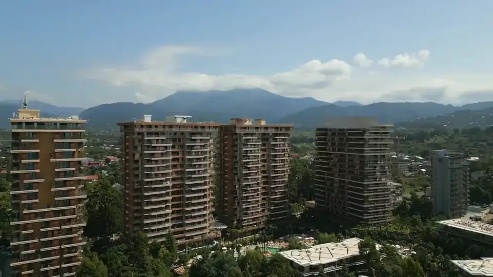 The high-rise blocks and the mountains behind the resort