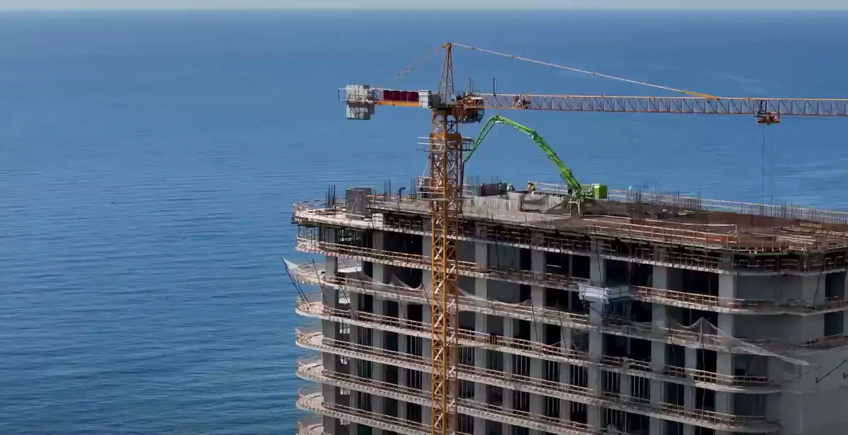 The top floors, the crane and the open sea, August 2026