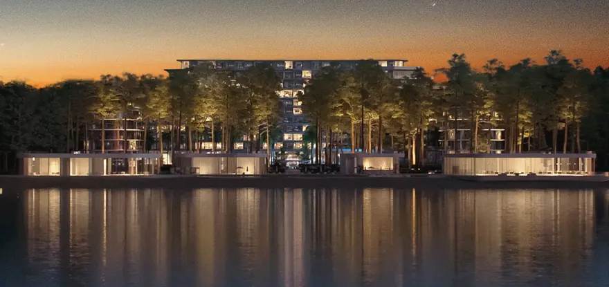 Rendering of the complex at dusk: lit blocks among the pines above the water